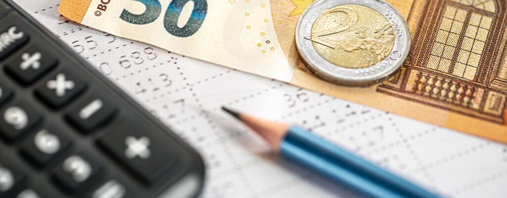 calculator money pencil closeup blurred background