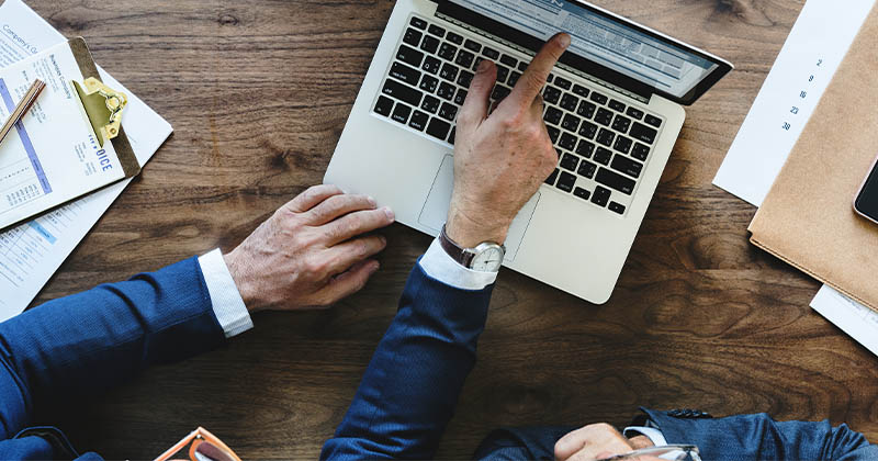 Laptop with two businessman