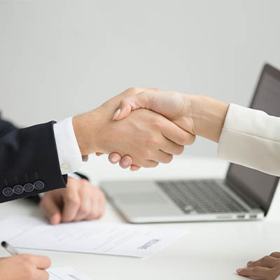 HR representative shaking hands with a successful candidate after being hired in France