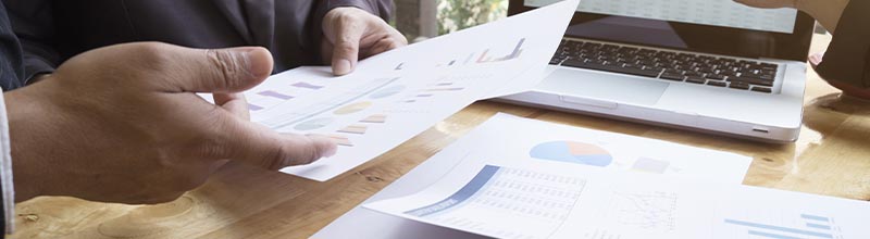 Written business proposal document being reviewed on a desk