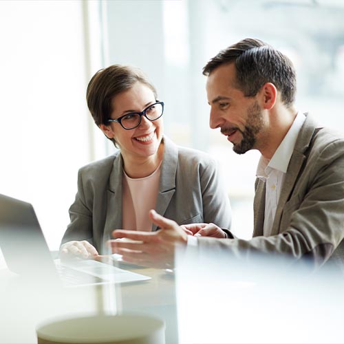 Two business colleagues reviewing information together on a laptop