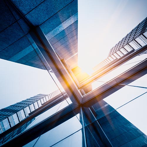 Low-angle view of glass office towers, symbolising corporate France