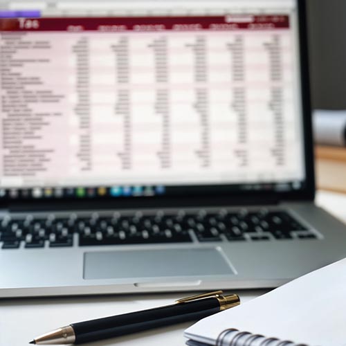 Laptop displaying a spreadsheet used for compliance planning